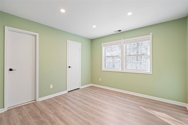 unfurnished bedroom with light hardwood / wood-style floors