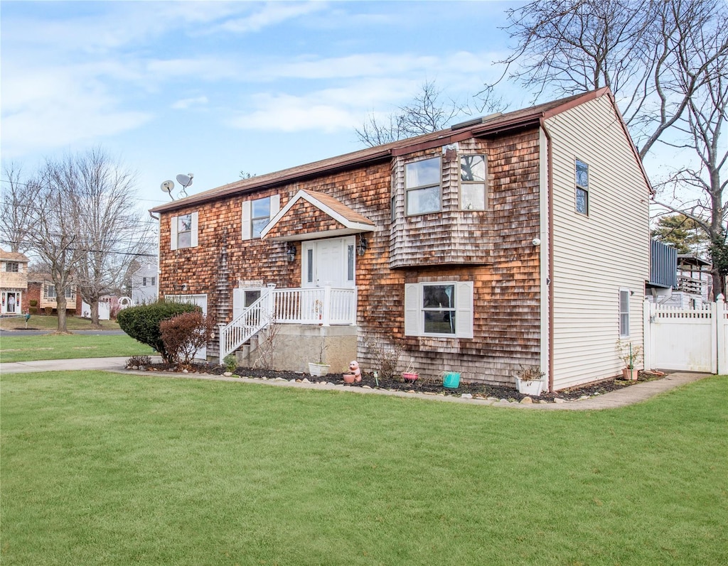 raised ranch with a front lawn