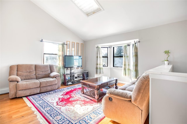 living room featuring hardwood / wood-style flooring and vaulted ceiling