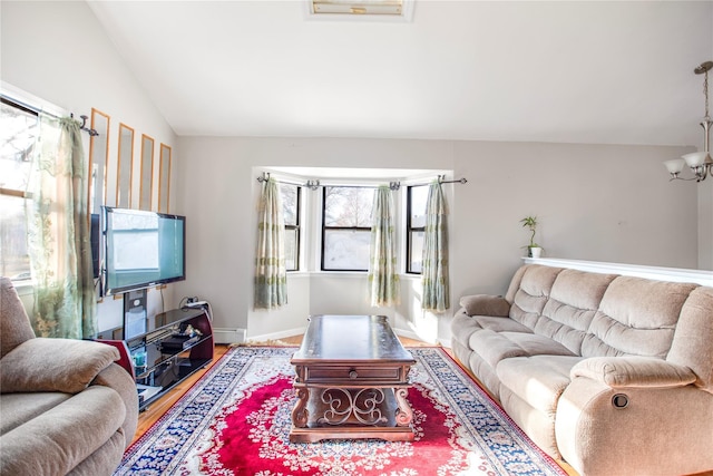 living room with a notable chandelier, hardwood / wood-style floors, vaulted ceiling, and a baseboard radiator