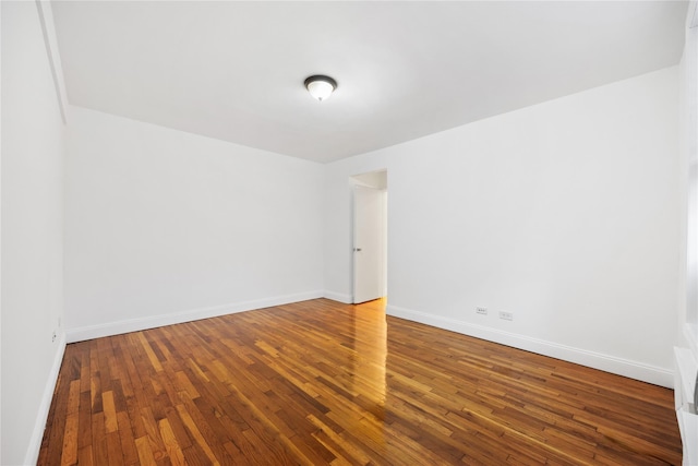 spare room featuring wood-type flooring