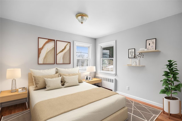 bedroom with hardwood / wood-style flooring and radiator