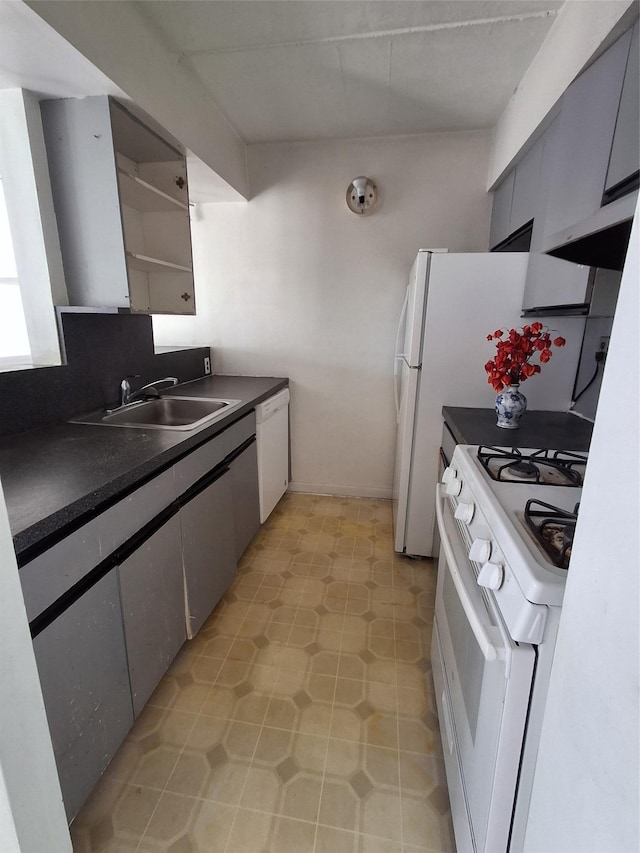 kitchen featuring gray cabinetry, sink, and white appliances