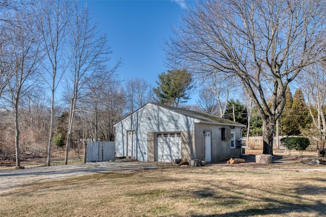 view of property exterior with a garage and a lawn