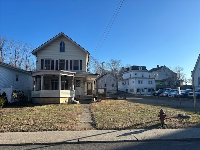 view of front facade featuring a front yard and covered porch