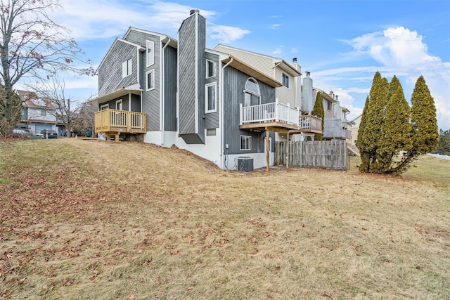 view of side of property with central AC unit and a yard