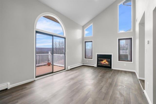 unfurnished living room with high vaulted ceiling, hardwood / wood-style floors, and a baseboard heating unit