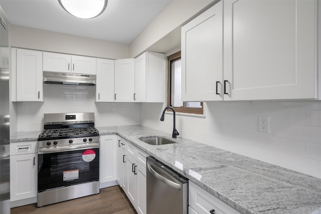 kitchen featuring light stone countertops, white cabinets, stainless steel appliances, sink, and dark hardwood / wood-style floors