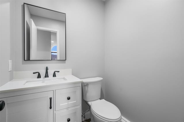 bathroom with toilet and vanity