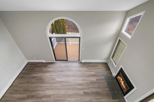 interior space with dark wood-type flooring and baseboard heating