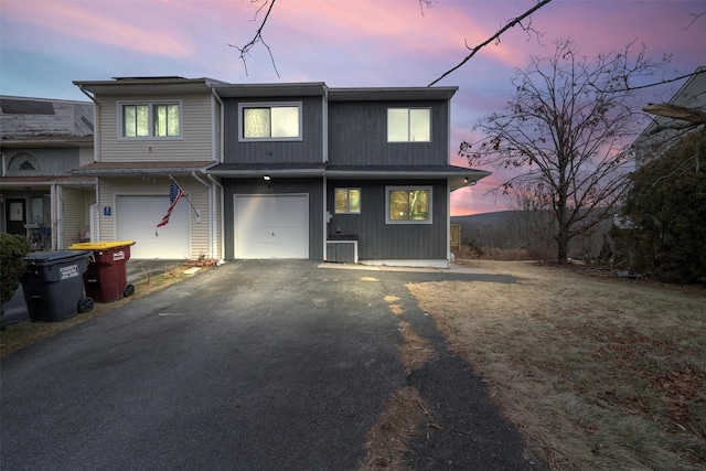 back house at dusk with a garage