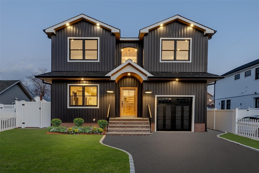 view of front of house with a yard and a garage