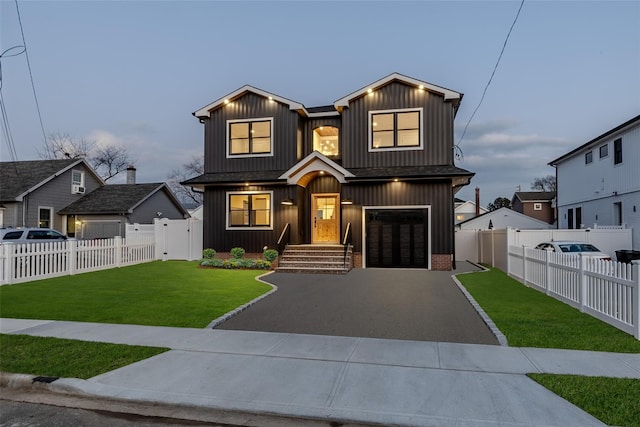 view of front of property featuring a yard and a garage