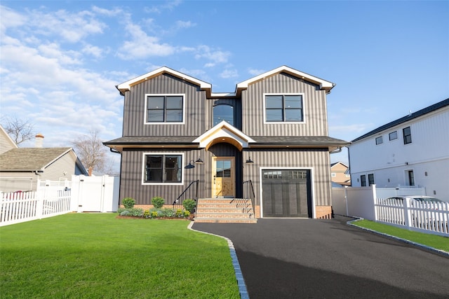 view of front of property featuring a front yard and a garage