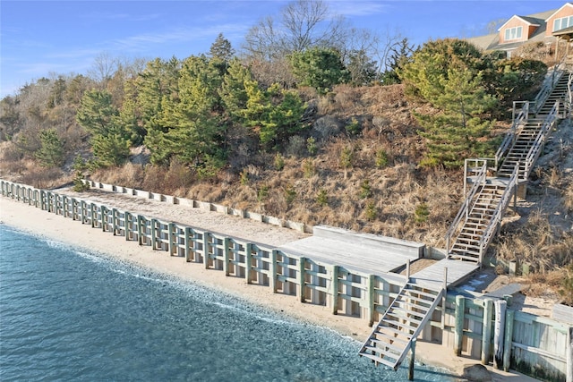 birds eye view of property with a view of the beach and a water view