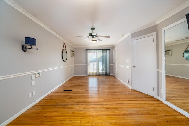 interior space with ornamental molding, ceiling fan, and light wood-type flooring