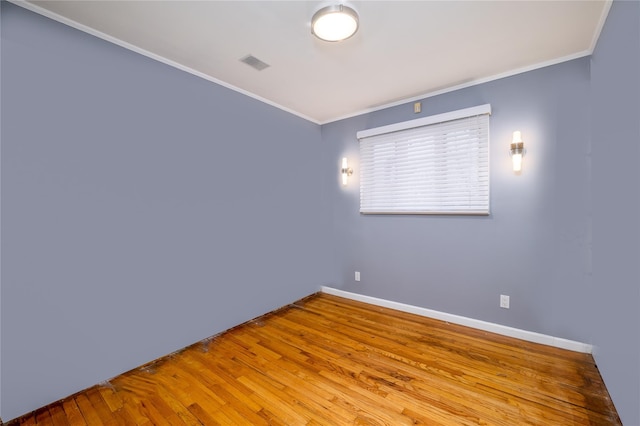 unfurnished room with ornamental molding and light wood-type flooring