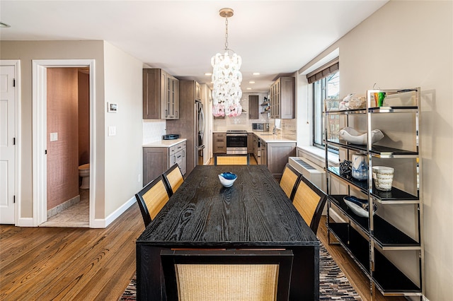 dining room with an inviting chandelier and dark hardwood / wood-style flooring