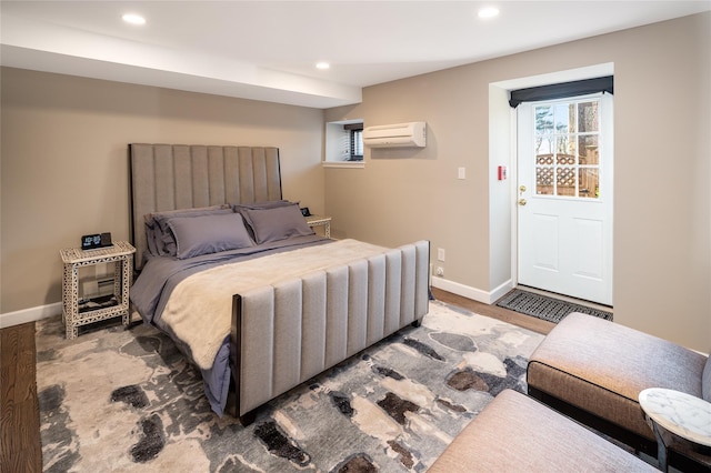 bedroom with dark wood-type flooring and an AC wall unit