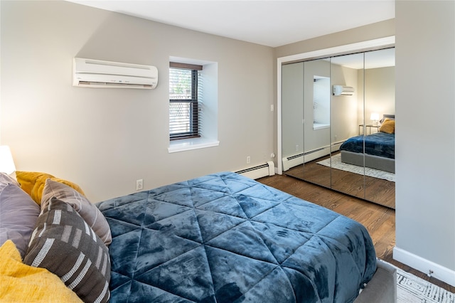 bedroom featuring wood-type flooring, an AC wall unit, a closet, and a baseboard radiator