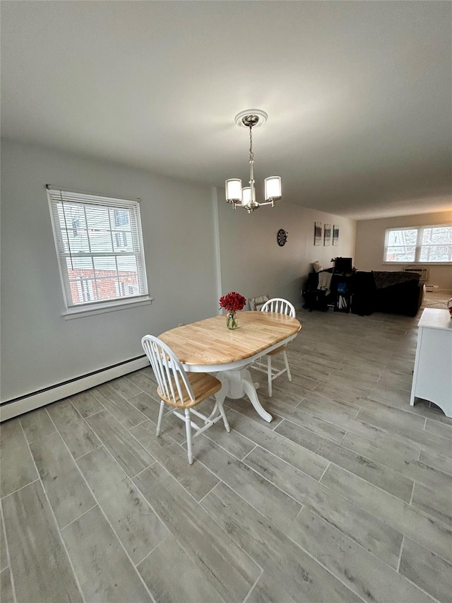 dining area featuring a notable chandelier and a baseboard radiator