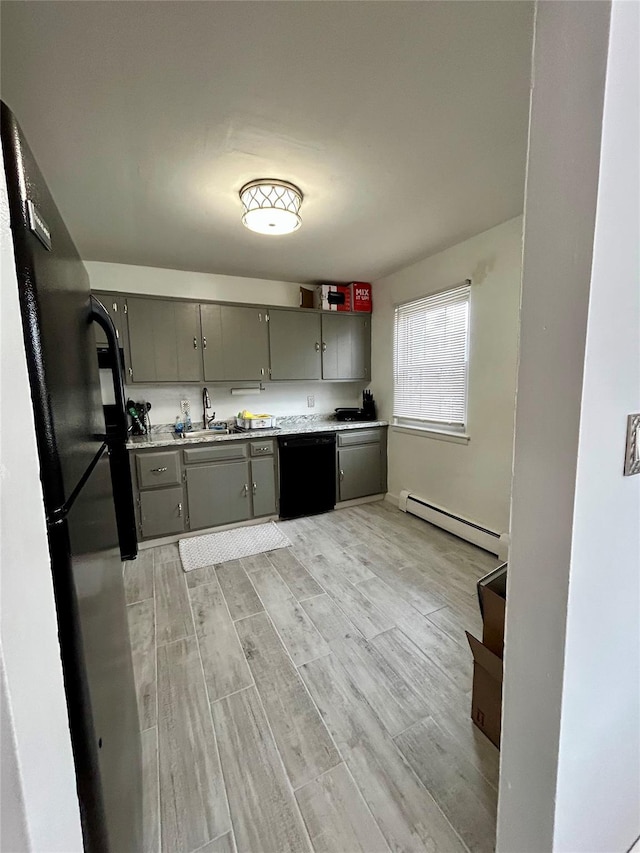 kitchen with sink, gray cabinets, baseboard heating, black appliances, and light wood-type flooring