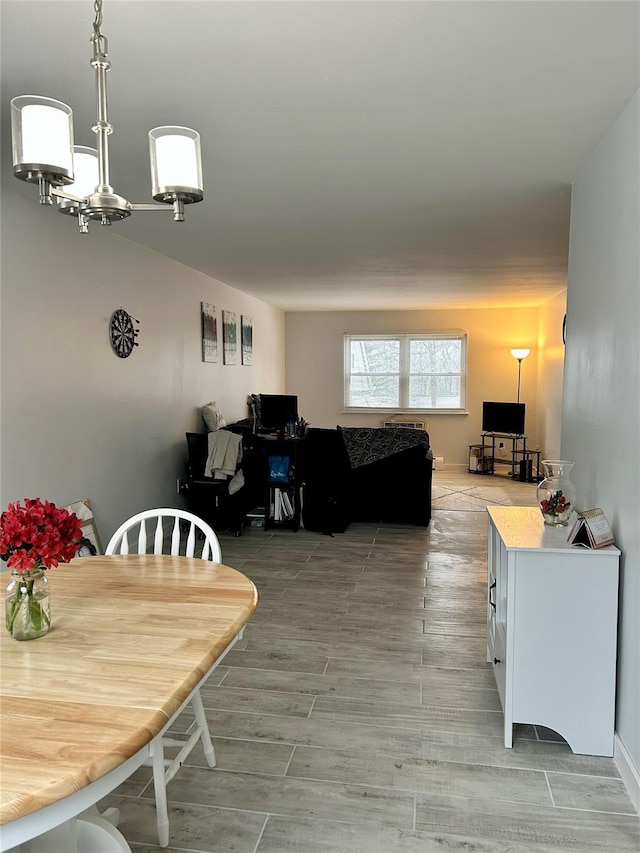 dining space featuring hardwood / wood-style flooring and an inviting chandelier