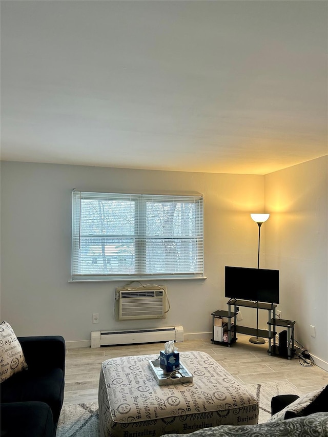 living room with light hardwood / wood-style flooring, a wall unit AC, and a baseboard heating unit