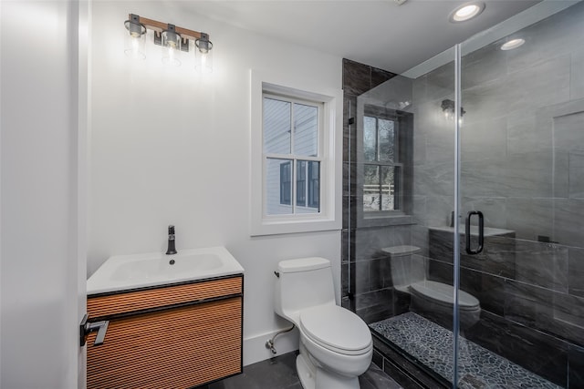 bathroom with toilet, vanity, tile patterned flooring, and a shower with shower door