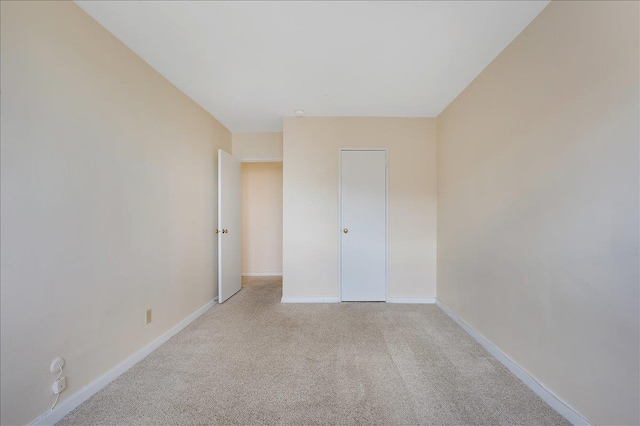 spare room with light colored carpet