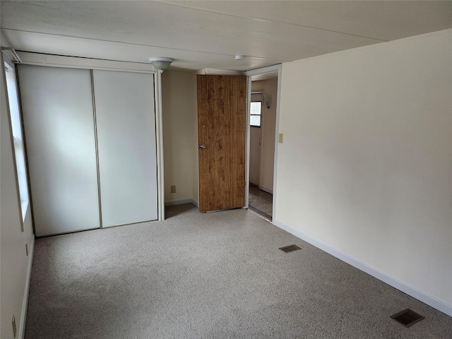 unfurnished bedroom with a closet and carpet floors