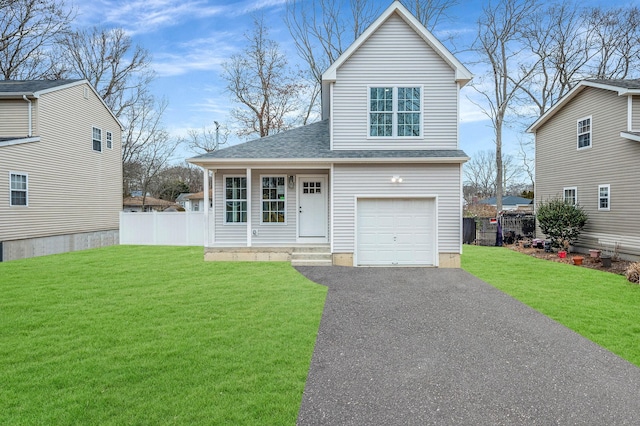 view of front of home featuring a front yard, covered porch, and a garage