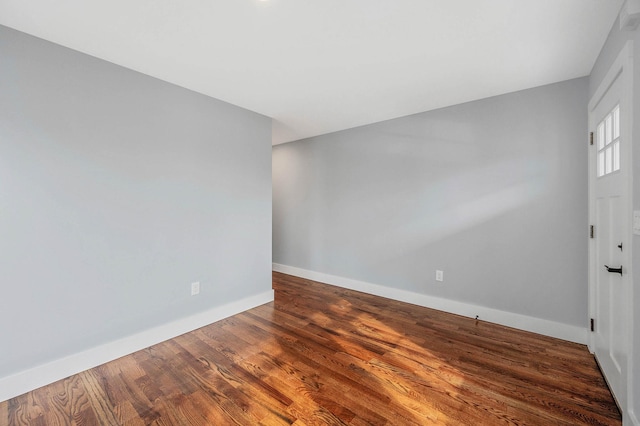 unfurnished room with wood-type flooring