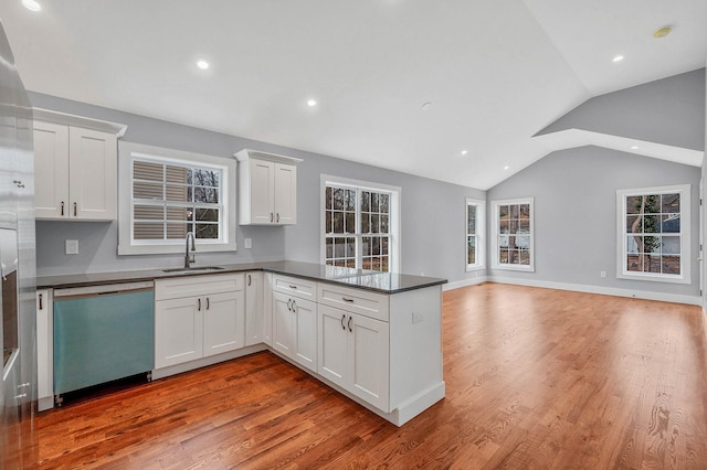 kitchen featuring white cabinetry, kitchen peninsula, dishwasher, light hardwood / wood-style flooring, and sink