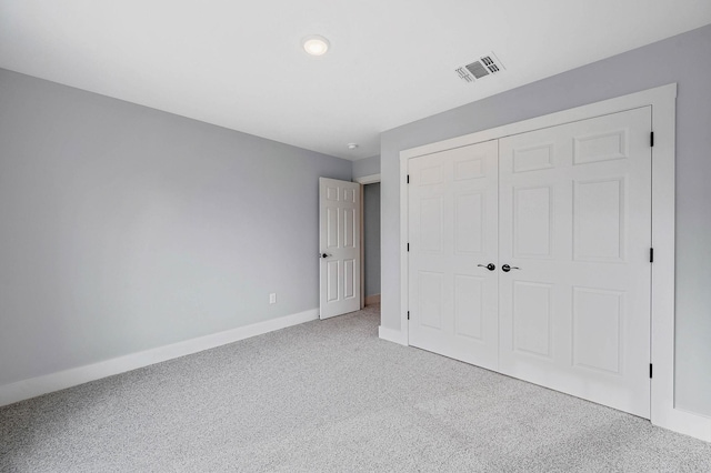 unfurnished bedroom featuring carpet floors and a closet