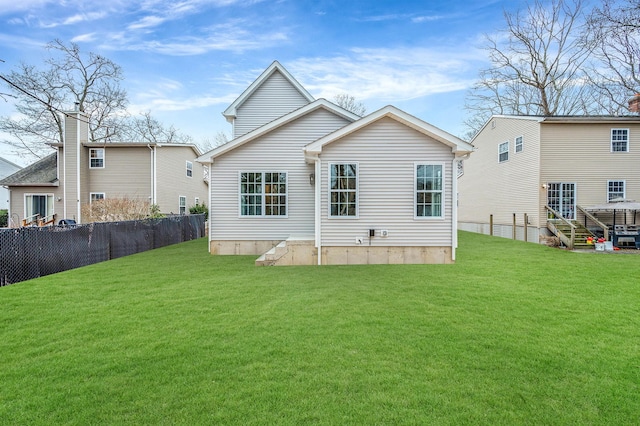 rear view of property featuring a yard