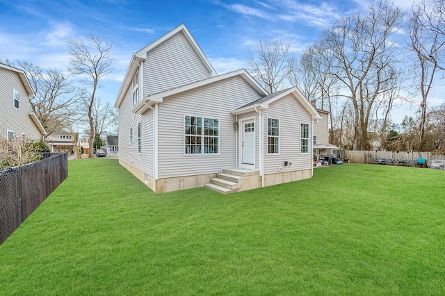 back of house with a lawn