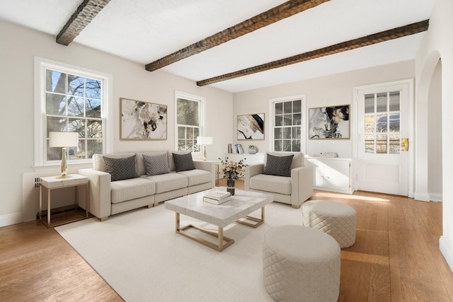 living room featuring light hardwood / wood-style floors and beamed ceiling