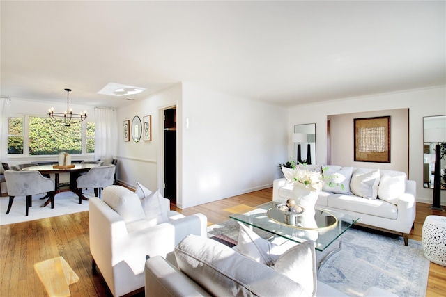 living room with an inviting chandelier and light hardwood / wood-style floors