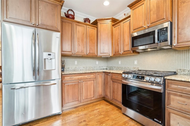 kitchen featuring light stone countertops, light hardwood / wood-style floors, tasteful backsplash, crown molding, and appliances with stainless steel finishes