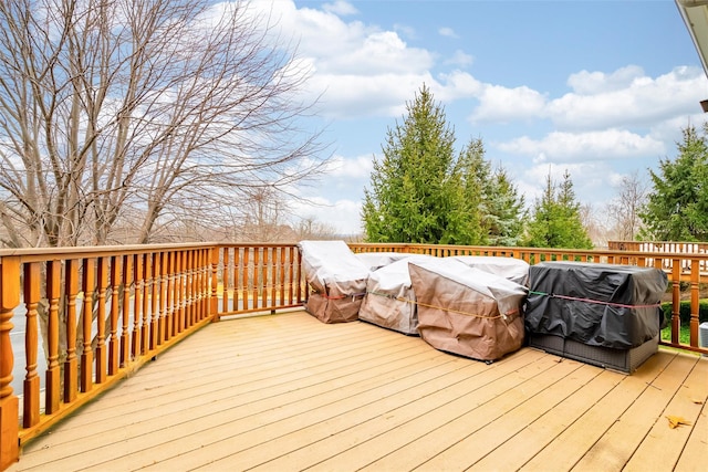 wooden deck with a grill