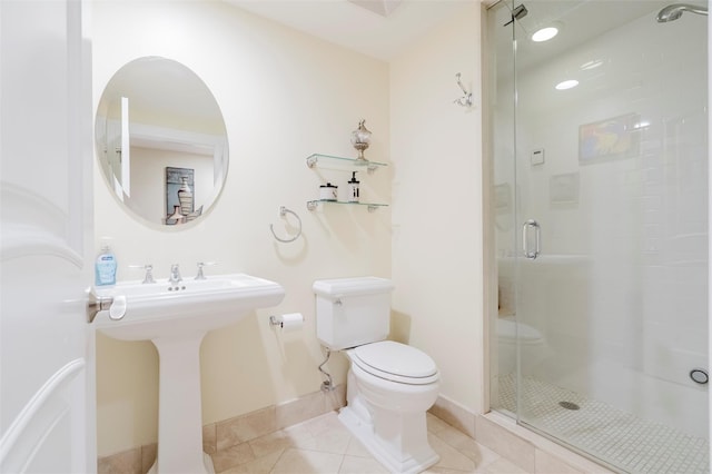 bathroom with toilet, tile patterned flooring, and a shower with shower door