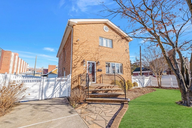 rear view of property featuring a lawn