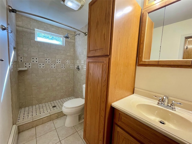 bathroom featuring toilet, a tile shower, tile patterned floors, a baseboard heating unit, and vanity