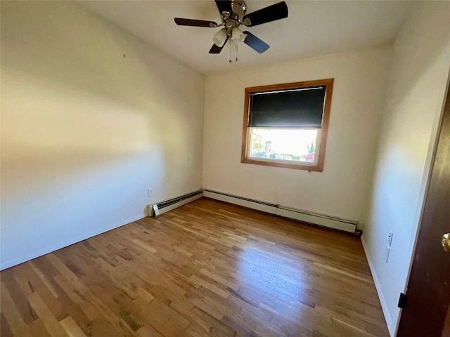 spare room with a baseboard heating unit, ceiling fan, and light hardwood / wood-style flooring