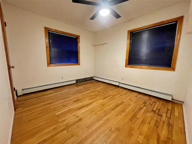 empty room featuring a baseboard radiator, ceiling fan, and light hardwood / wood-style floors