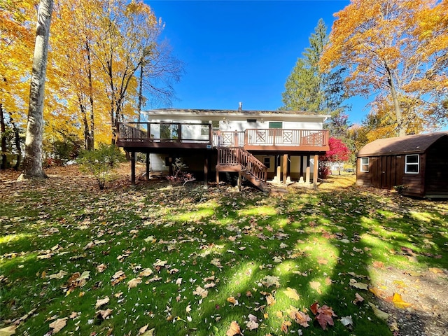 rear view of property featuring a storage unit, a deck, and a lawn