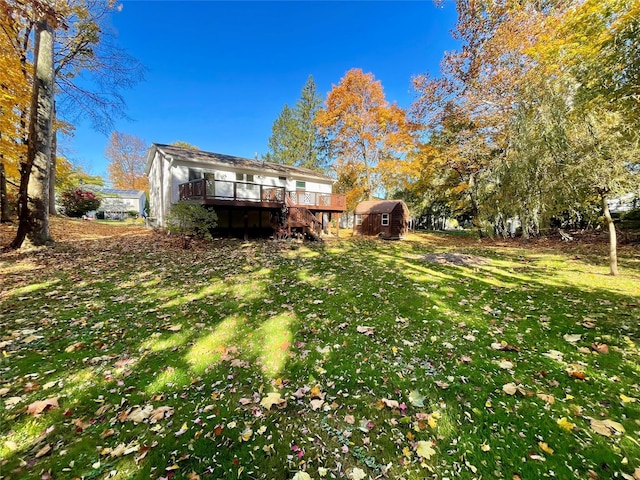 view of yard with a shed and a wooden deck