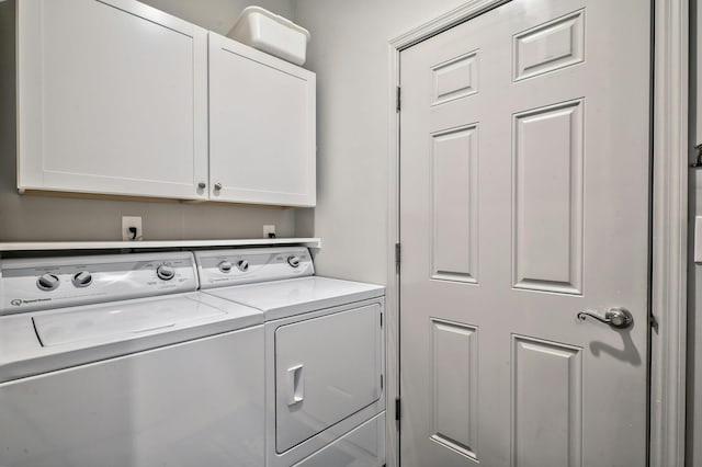 washroom featuring washer and dryer and cabinets