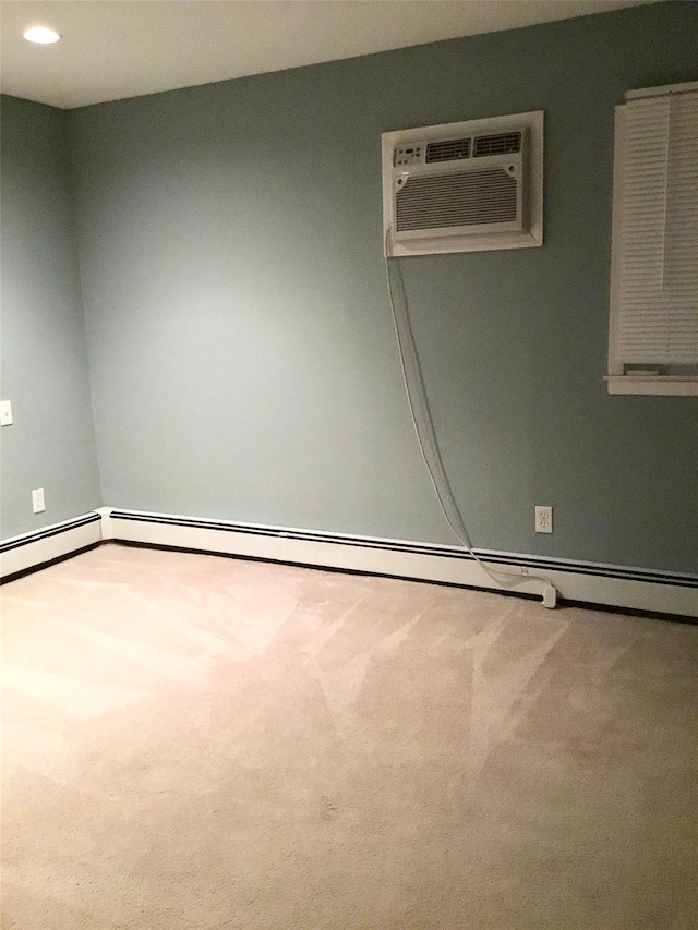 carpeted spare room featuring a wall unit AC